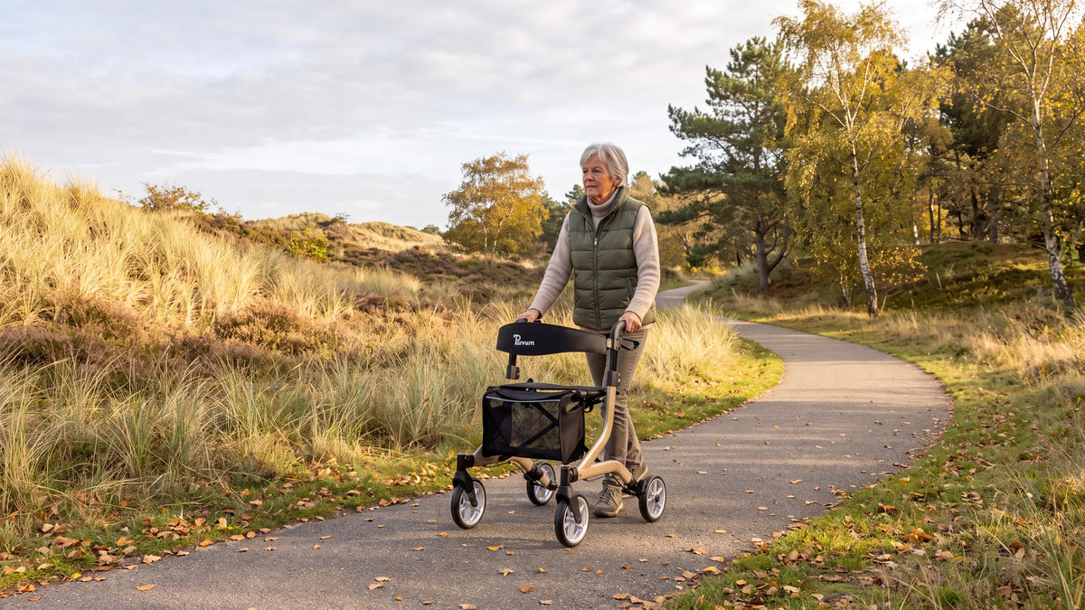 Parvum SuperLight Plus in champagne on a dune path; a woman with gray hair walks with the rollator.